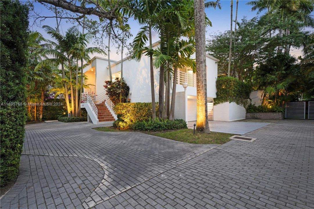 Located in the prestigious North Coconut Grove, this sophisticated 3 level home is set on a gated, landscaped 9,000 SF Corner lot. With 5 BR & 4.5 BA