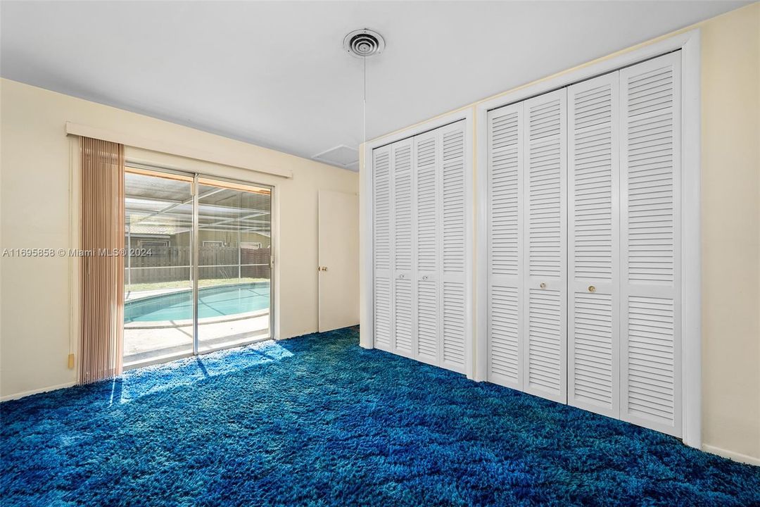 Second bedroom with view of pool