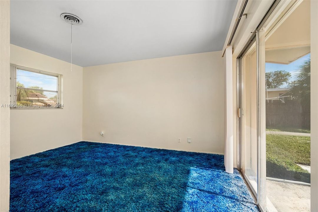 Second bedroom with view of pool