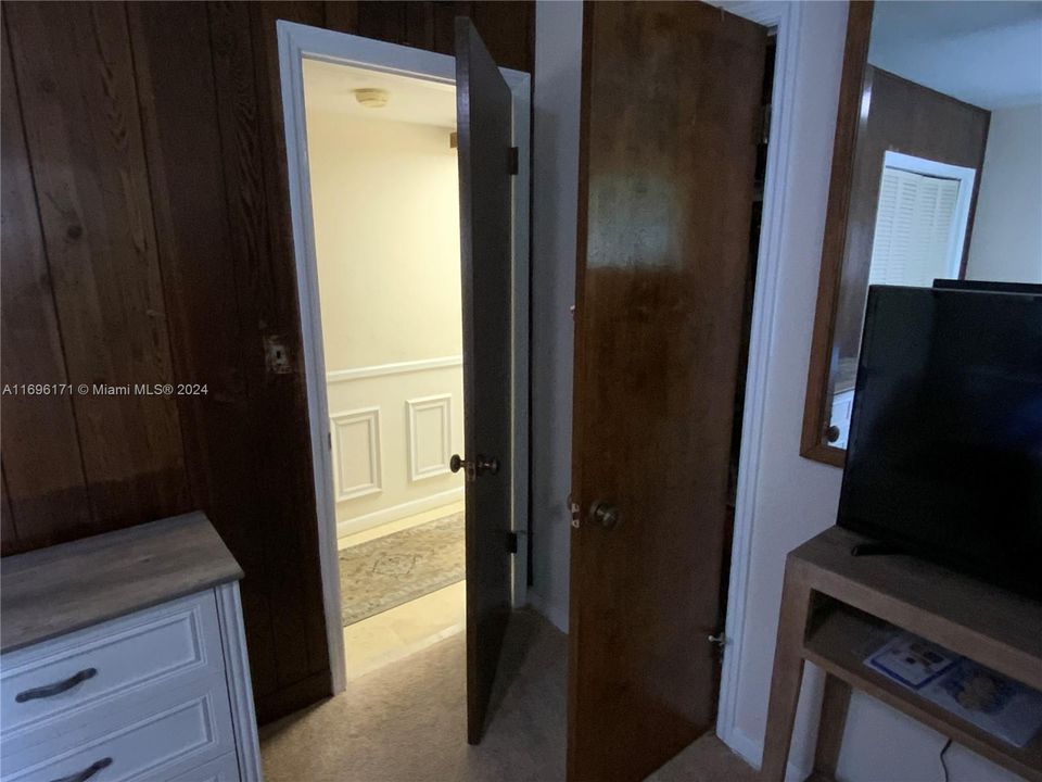 Doors to hallway and walk-in closet in master bedroom