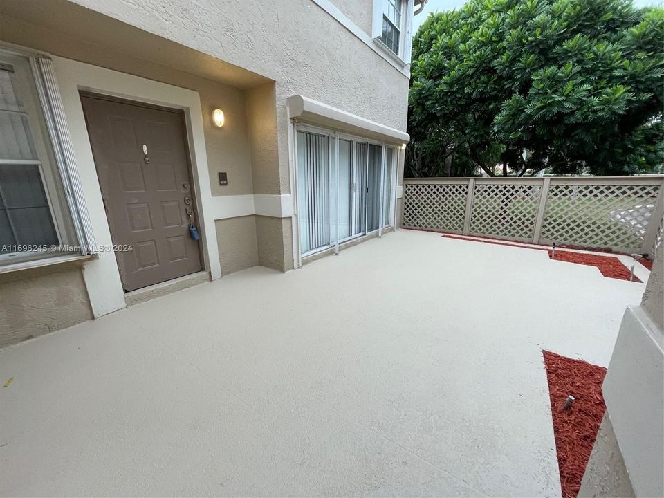 Front entry through fenced courtyard