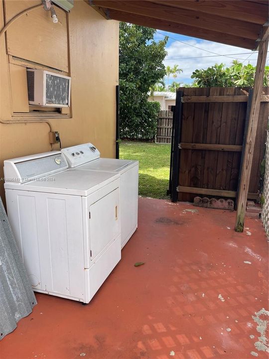 Washer and dryer located outside the back of the unit.