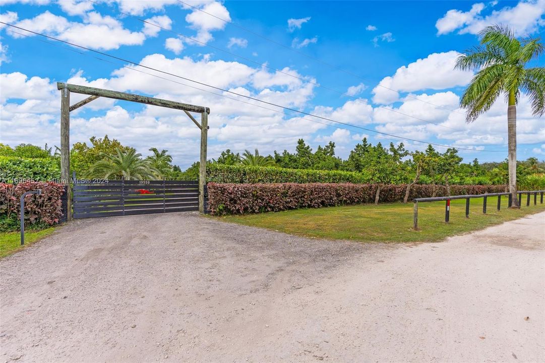 PERFECTION AS YOU ENTER THE PROPERTY W/ THE CUSTOM GATE & LUSH LANDSCAPING. VERY WELCOMING