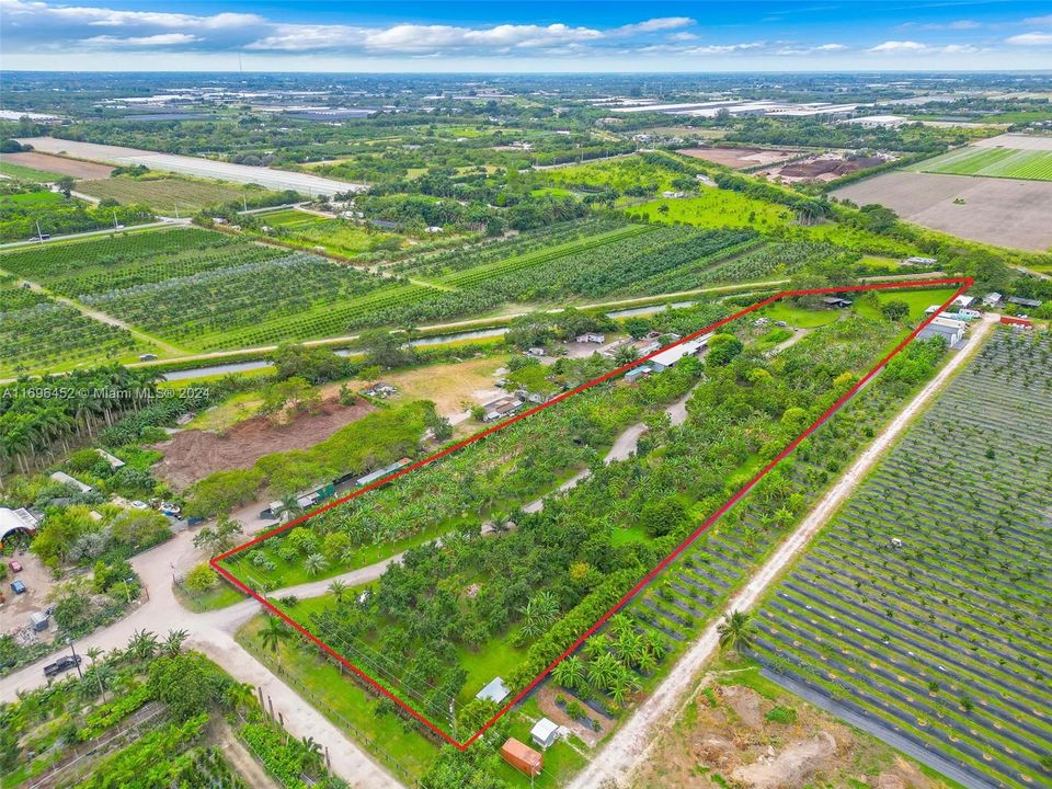 5 ACRE AGRICULTURAL PARADISE W/ INFRASTRUCTURE INCLUDING ASST FRUIT GROVES, WAREHOUSE, OFFICE , BARN FOR LIVESTOCK, CHICKEN COOP & CARETAKERS QUARTER . FULLY IRRIGATED WITH LIGHTING THRU OUT. THE WEST TIP IS SITTING ON A CANAL LOADED W FISH...HIGH AND DRY.. EAST OF KROME AVE AND CLOSE TO TOWN , VERY PRIVATE, IDEAL SITE FOR HOME, FARM OR VENUE