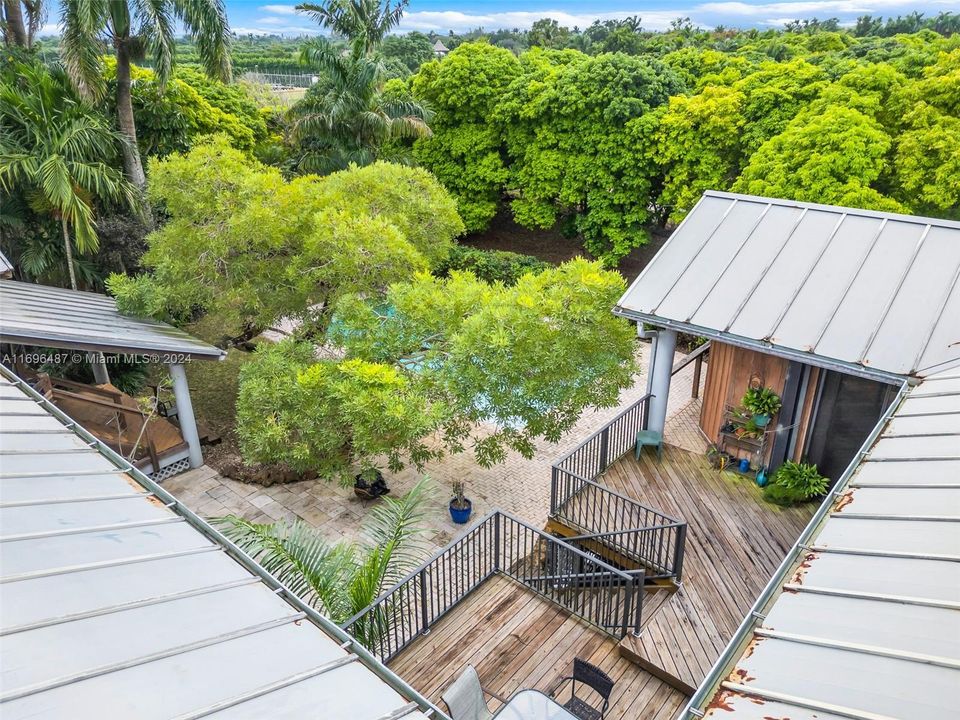 AERIAL VIEW OF THE HOME, WITH THE POOL AND  PATIO'S, PAVERED POOL AREA, ALL CROSS FENCED FROM THE REST OF THE PROPERTY