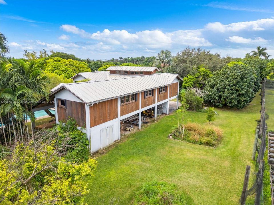 ADDITIONAL STORAGE IN COVERED REAR AREA OF HOME, ADDITIONAL PARKING UP TO 6..THE GENERATOR IS LOCATED HERE. NOTICE HOUSE DESIGNED TO ALLOW VENTALATION THRU TOP WINDOWS IN LIVING AREA