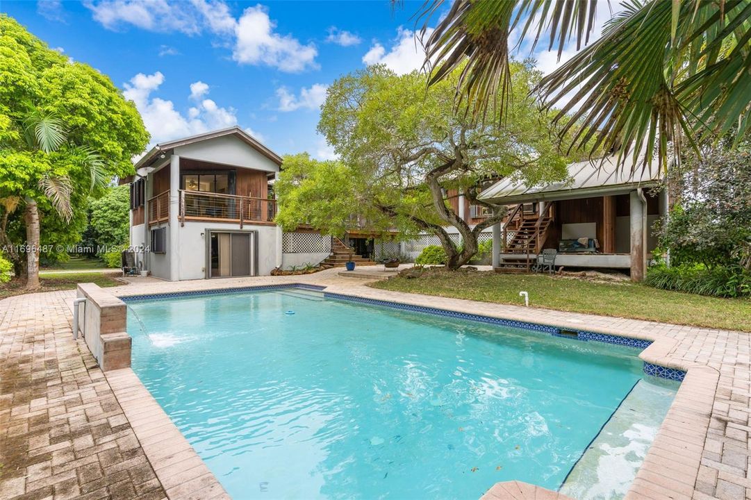 POOL AREA W/ PAVERED DECK, SITTING AREA'S LUSHLY LANDSCAPED W/ WATERFALL AND SITTING AREAS WITHIN THE POOL. JUST AWESOME