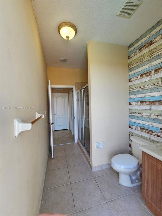 Downstairs full bath serving as both pool bath and also 1st floor bedroom bath