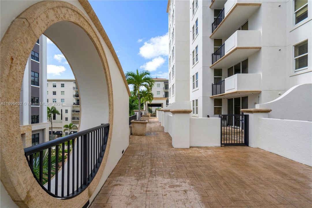 View showing significant more depth to this unit's patio, than the others on the same floor. Gate access from the patio to jogging trail and pool.