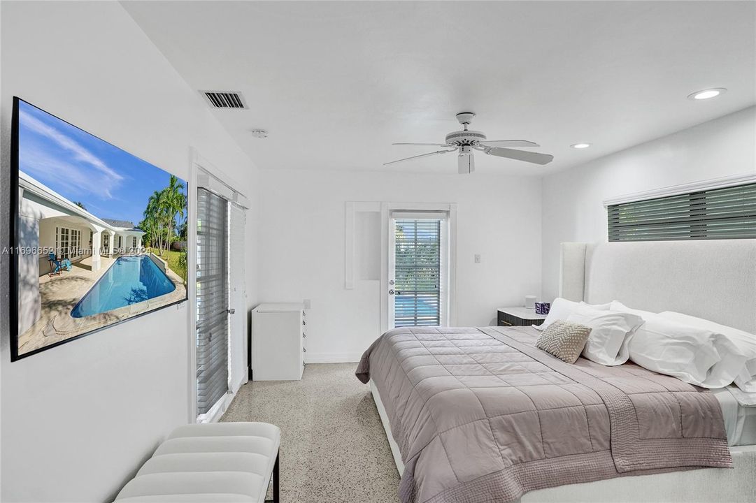 Primary bedroom, with door opening to pool area