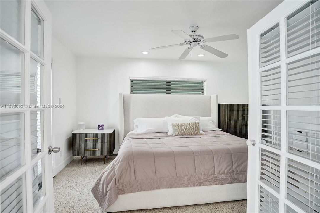 Primary bedroom, with door opening to pool area