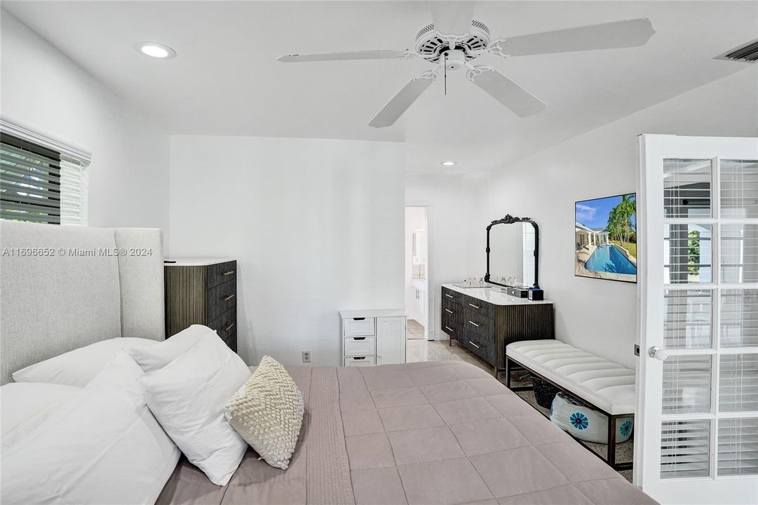 Primary bedroom, with door opening to pool area