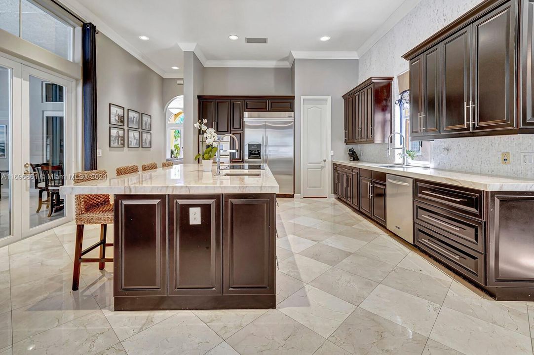 Kitchen island and stainless steel appliances.