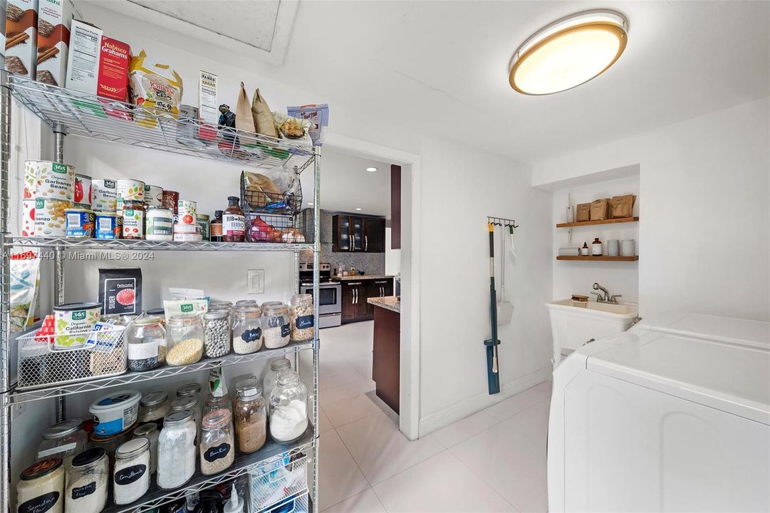 Enormous panty/laundry/multi-functional space that steps out to the carport.