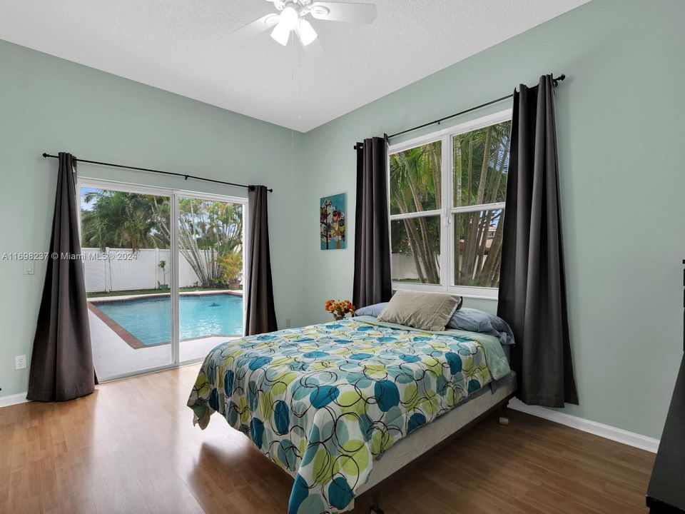 Bedroom with pool access and view