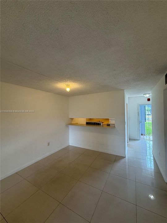 Dining Area, with bar table with window opening to kitchen.