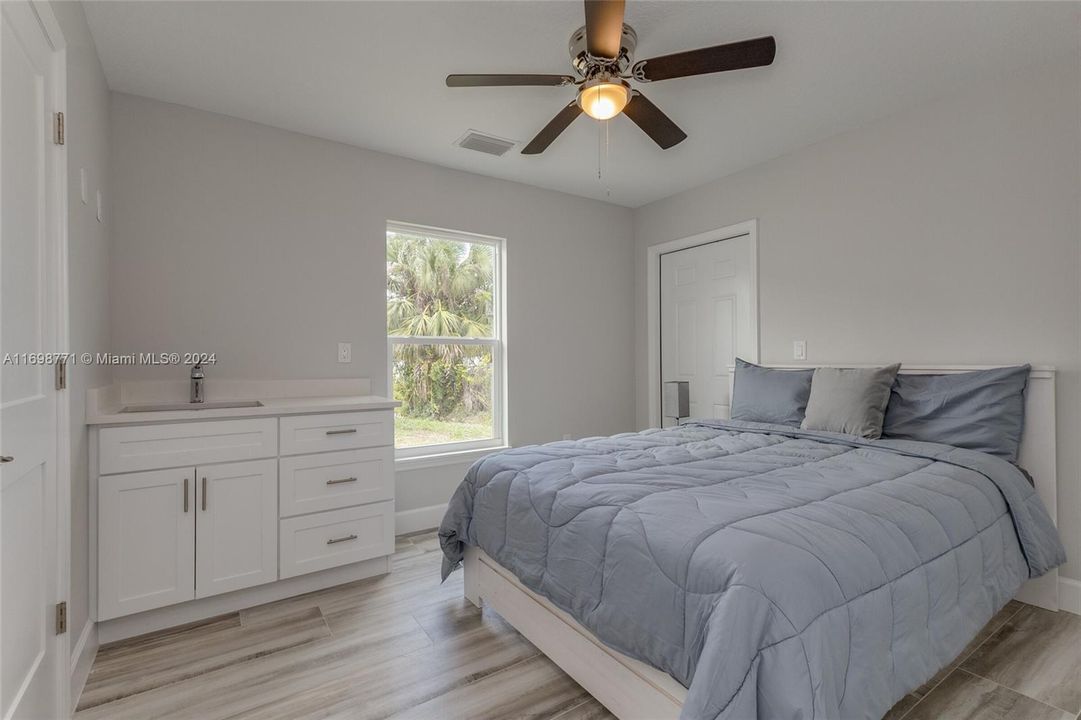 Main House Bedroom 3 with View to Kitchenette and Exterior Door