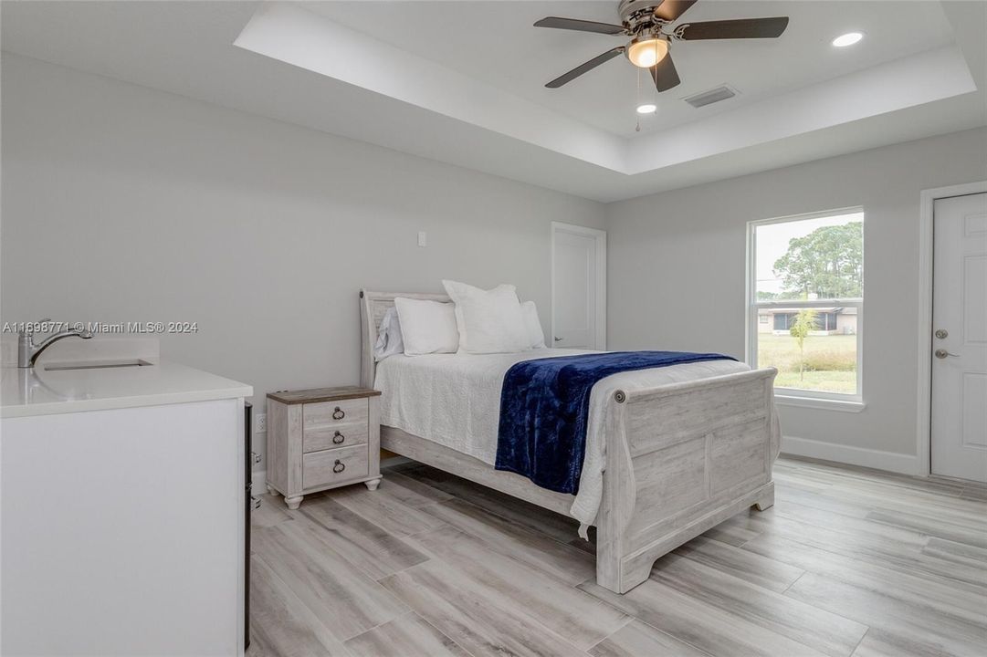 Main House Primary Bedroom with View to Exterior Door to Backyard