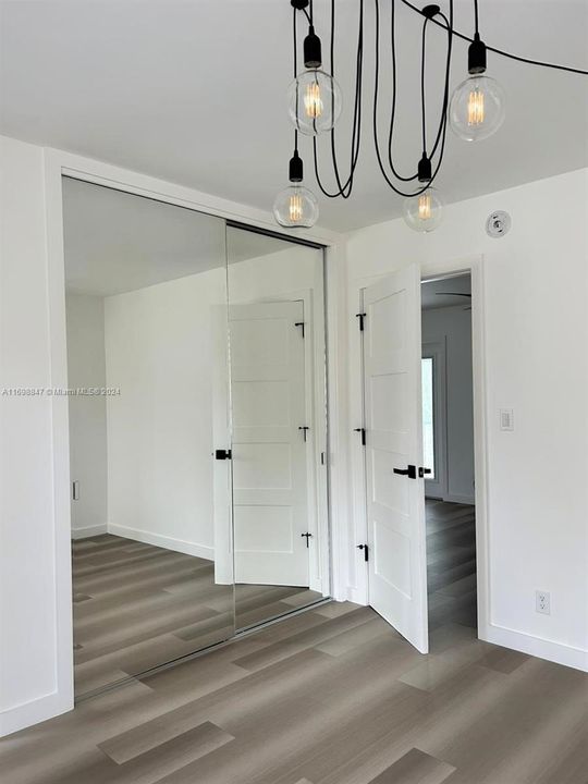 Primary bedroom with mirrored closet doors