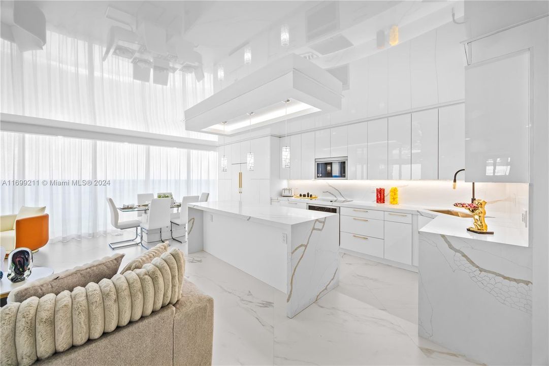 Kitchen and dining area with sheer curtains closed.