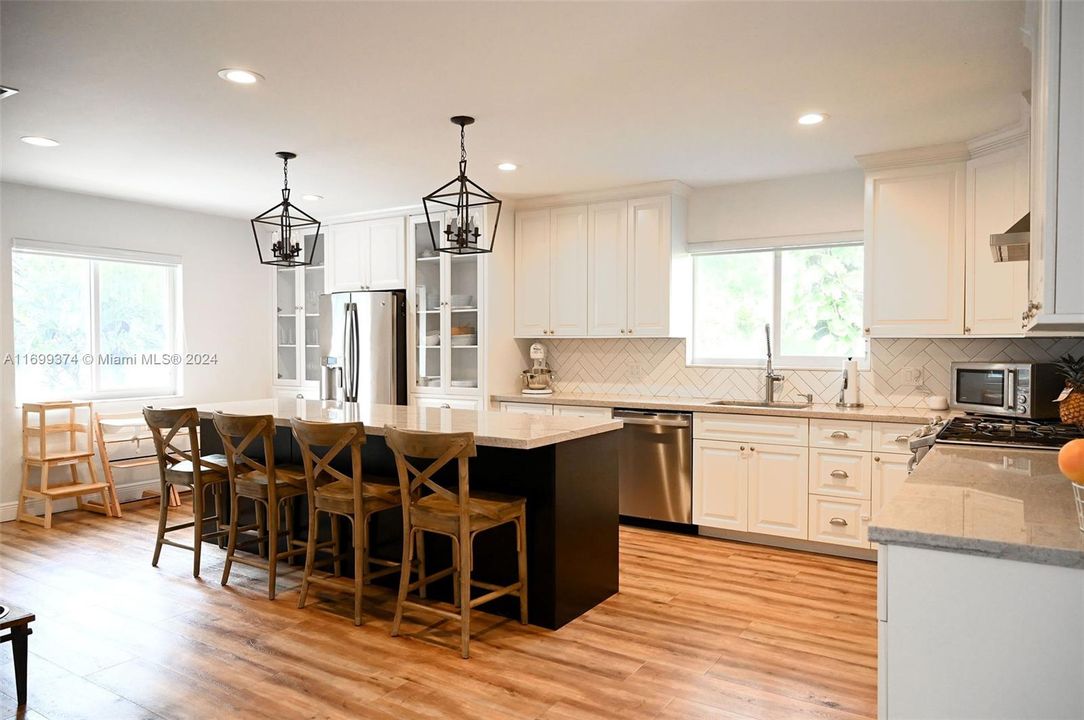 Ceiling height upper cabinets, quartz countertops, ss appliances, gas stove, and custom center island.