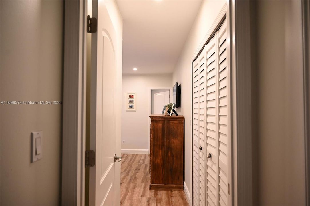 Enter primary bedroom, his and hers custom and lighted closets.