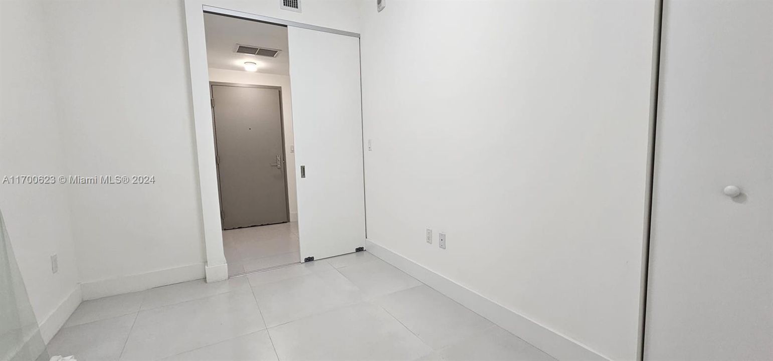 Enclosed Den and view of front door of unit