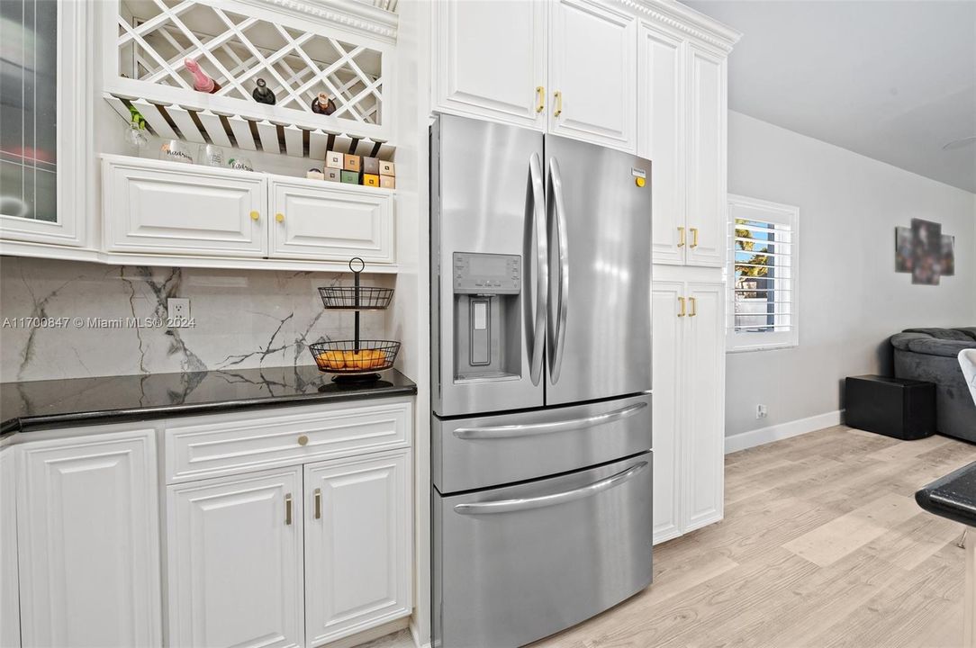 An open concept kitchen with tons of counterspace and large pantry.