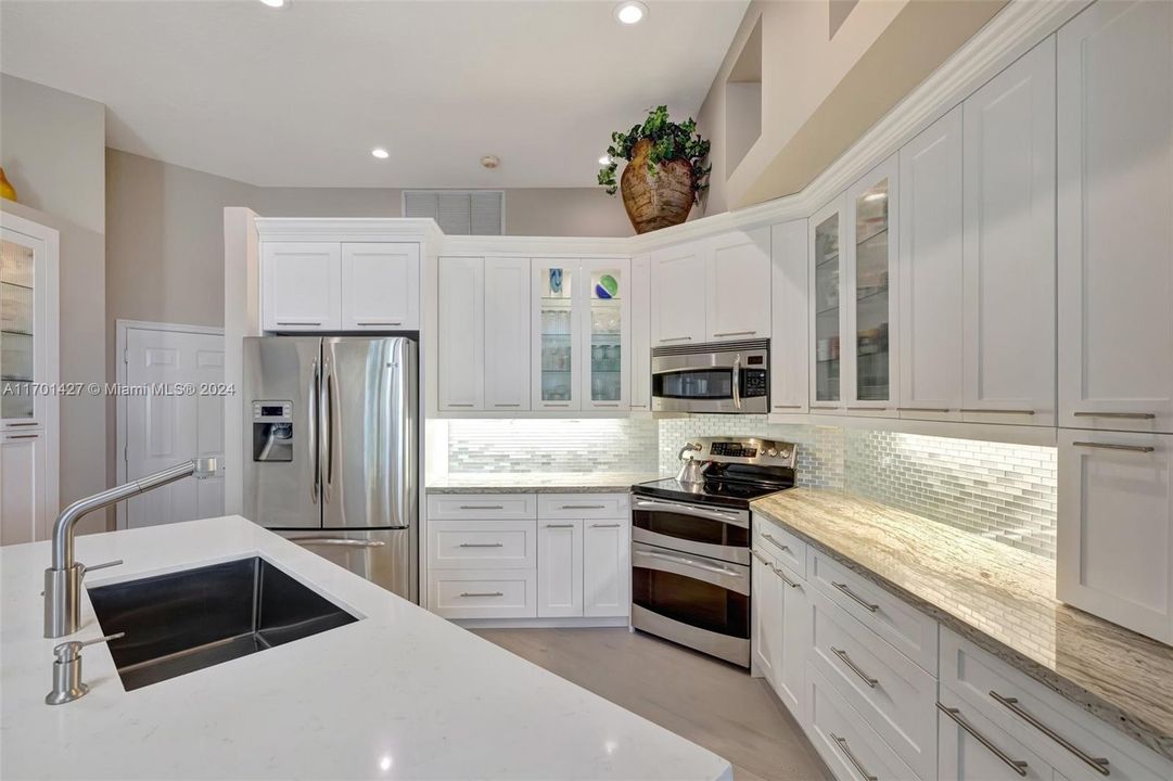 Custom Kitchen w/ Glass cabinets & backsplash, double oven, center island