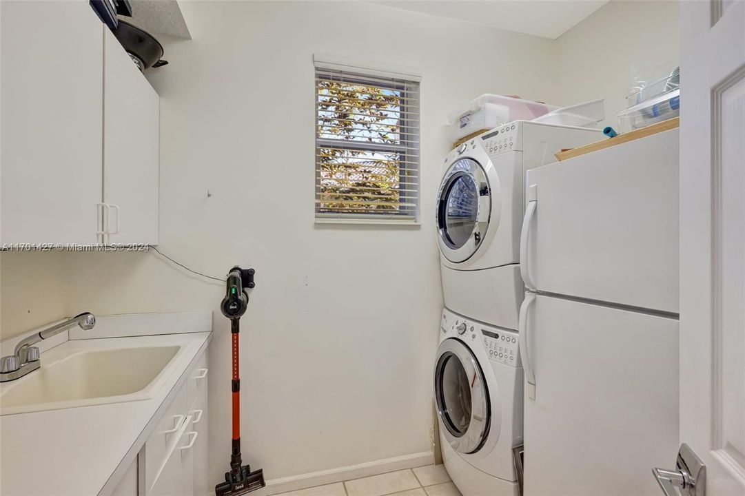 Laundry room w/ sink and room for extra refrigerator