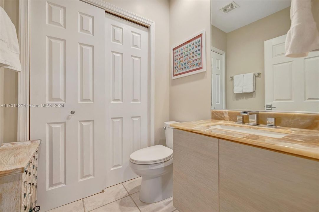 Full guest bathroom w/ combo tub / shower (currently used as closet). Onyx oounter