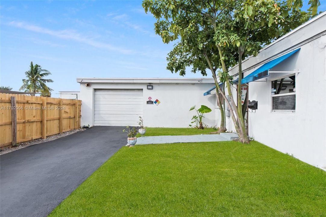 Front elevation featuring walkway and garage