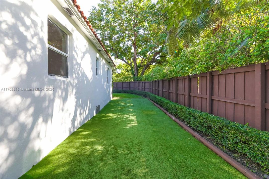 Side Yard view- Fully fenced in corner lot home - right side access to backyard pool & patio