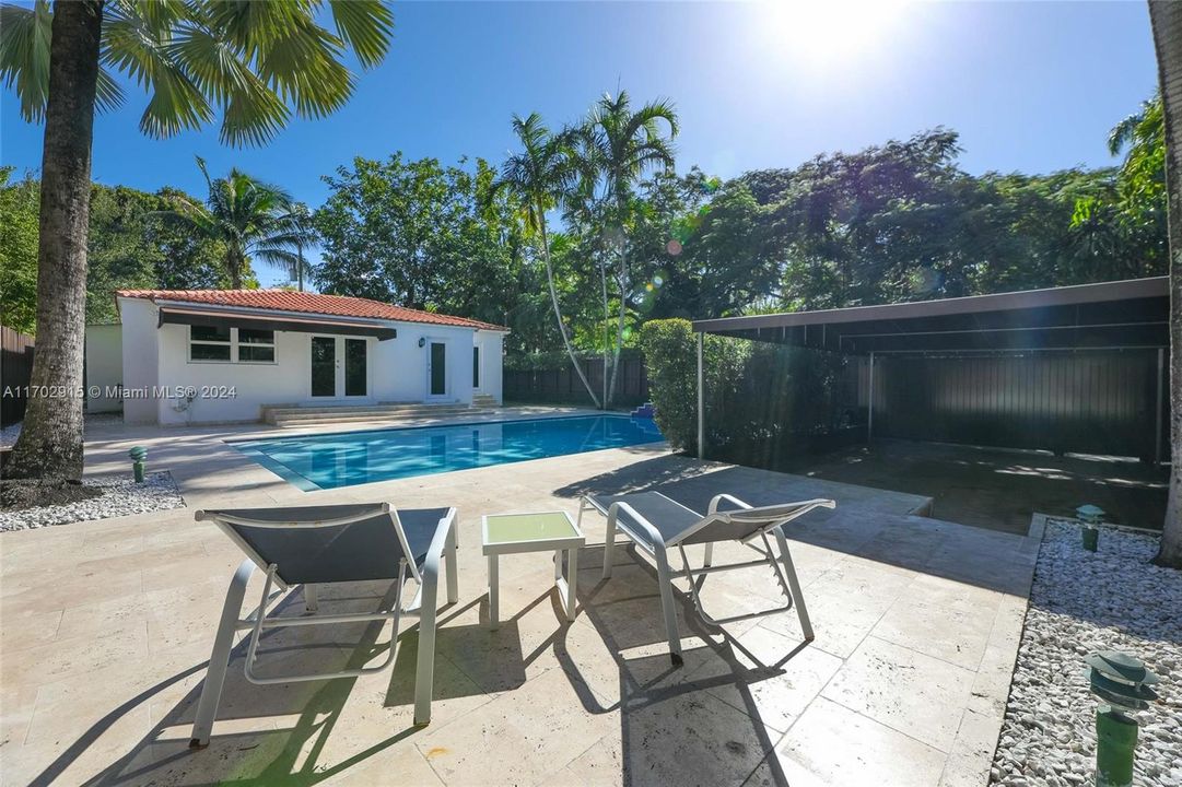 View of the pool and the covered 2-4 Covered/Gated Carport