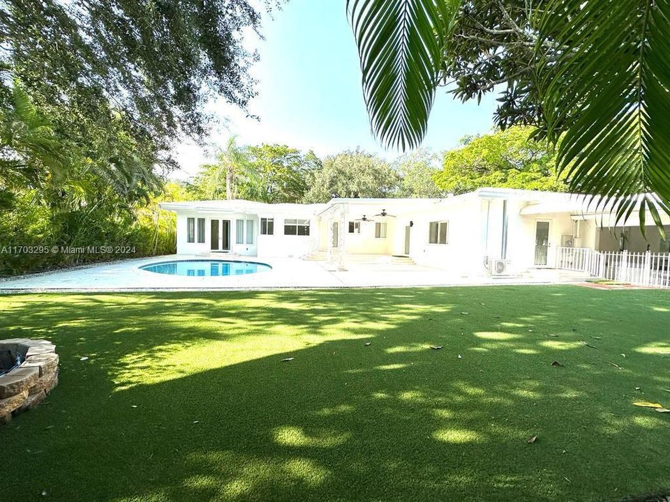 Beautiful backyard with artificial turf and saline pool