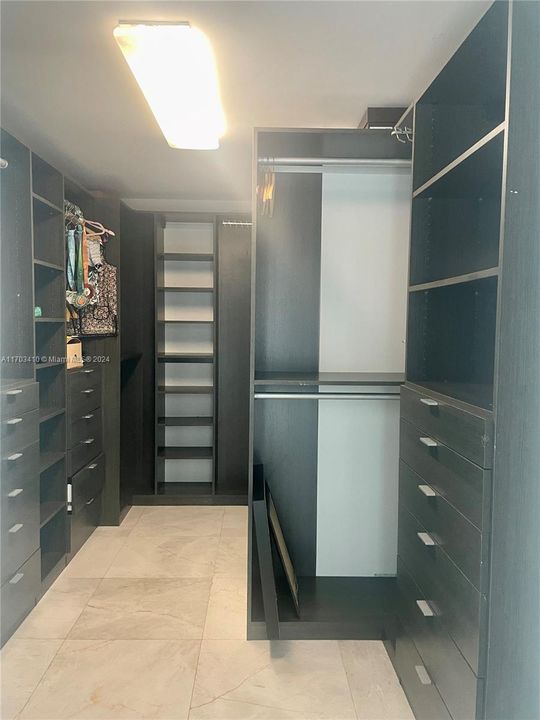 Walk-in closet in primary bedroom.