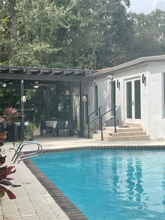 Backyard with pool and pergola.