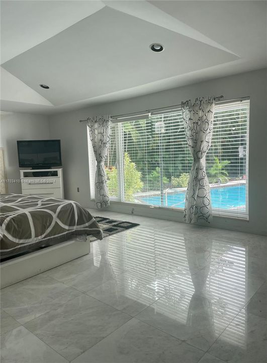 Primary bedroom overlooking the pool.