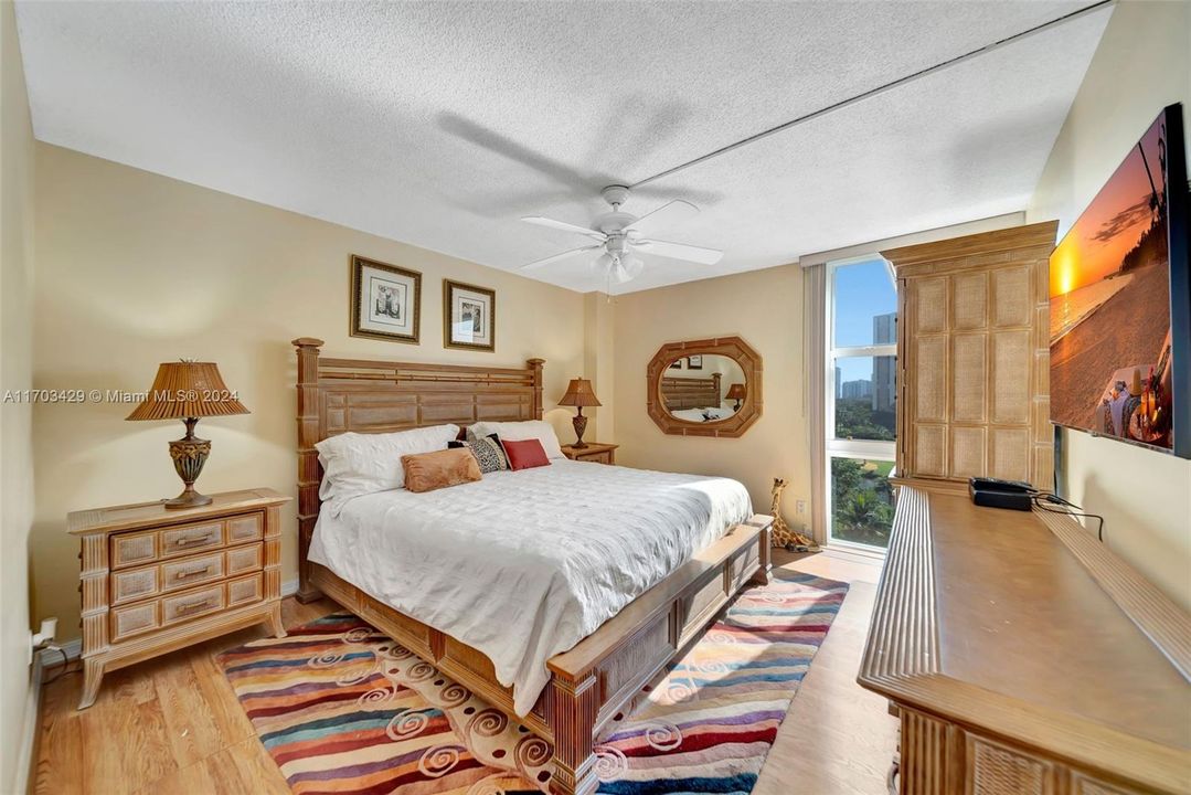 Spacious Bedroom with floor to ceiling hurricane impact window