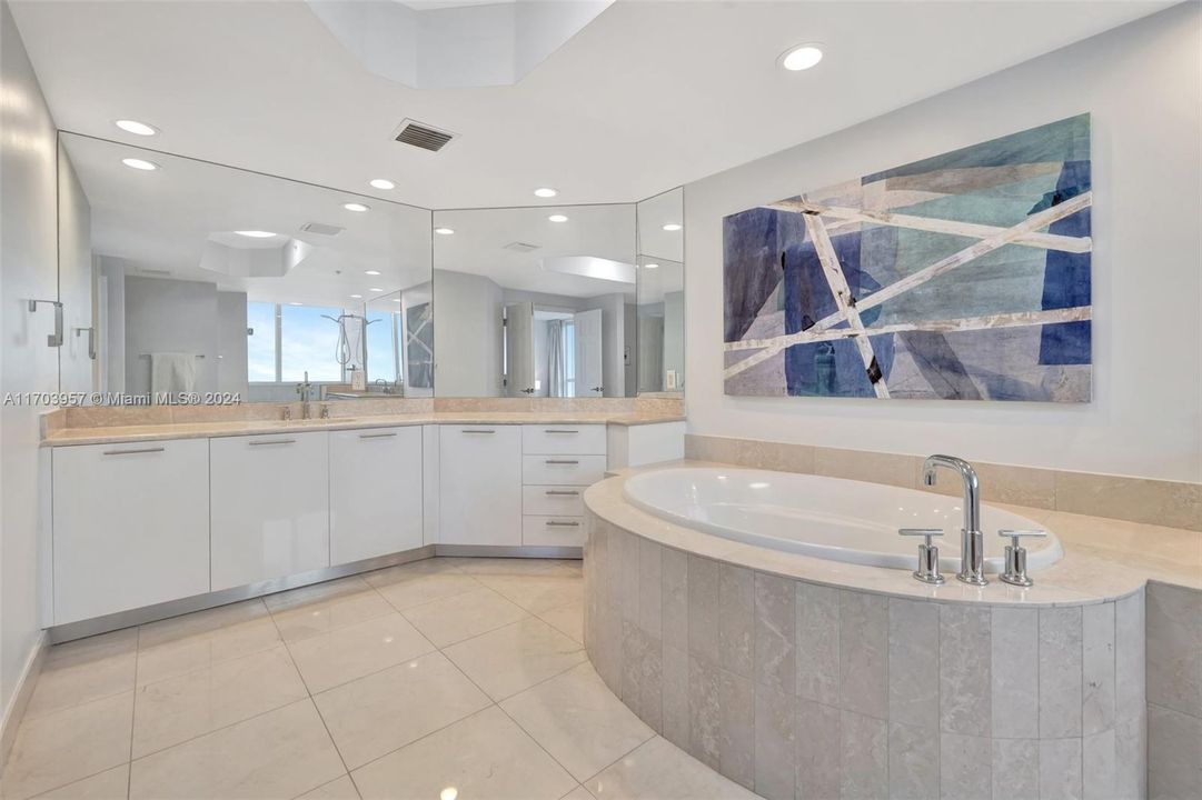 Marble bathroom w/ custom tub surround. Dual vanity. Jacuzzi Tub and walk in shower w/ window