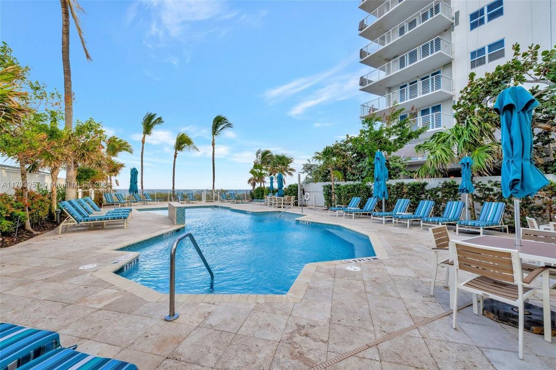 Pool area w/ Beach just behind it.