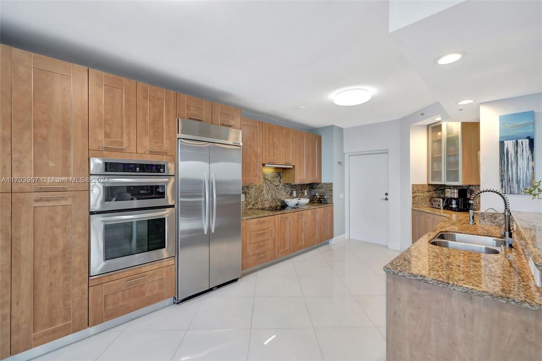 Pantry storage on the left of microwave & oven.