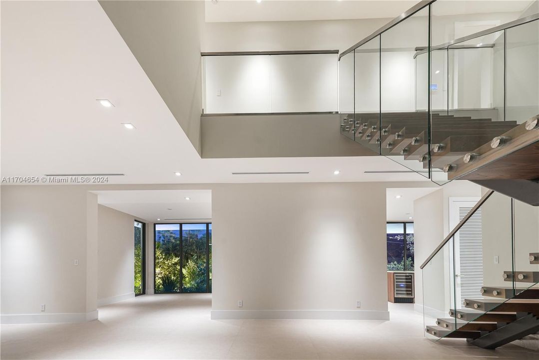 Soaring two-story foyer flows into living and family spaces