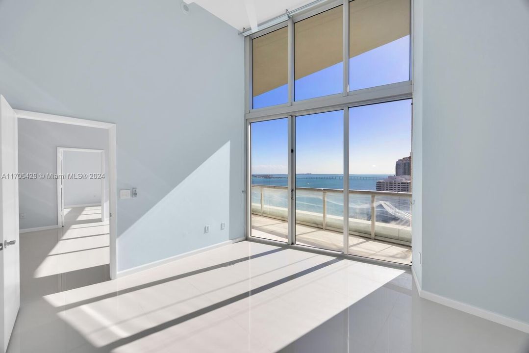 Direct bay views through 16 foot floor to ceiling hurricane resistant windows