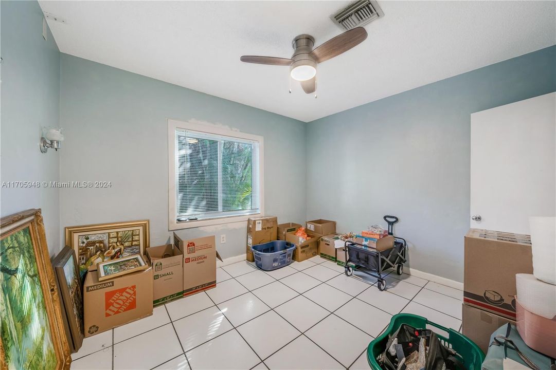 Owners have begun to pack and this bedroom is being used to store their boxes.