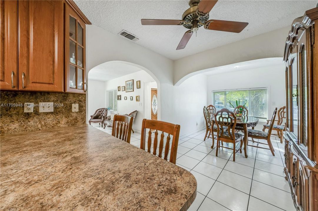 Breakfast counter, views of living & dining rms & foyer in the background.