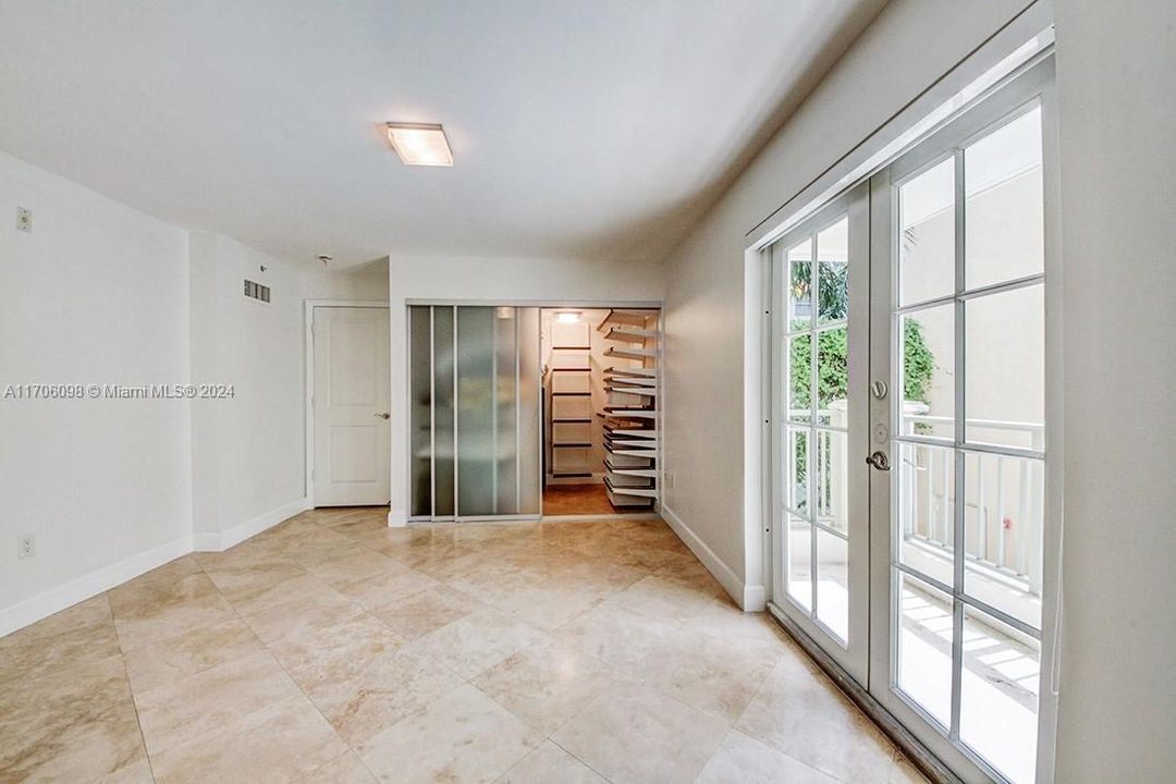 Master bedroom with balcony and walk-in closet