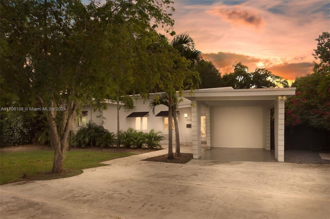 Ample parking for multiple vehicles w/wide driveway and covered carport.