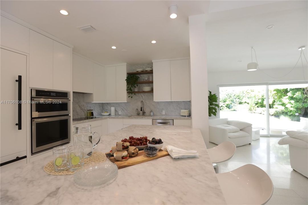 Spectacular crisp clean quartz counter tops and stainless appliances in this open concept floor plan.