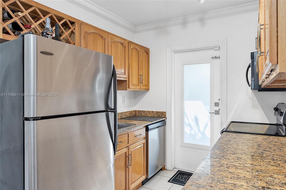 Updated kitchen with stainless steel appliances and granite countertops